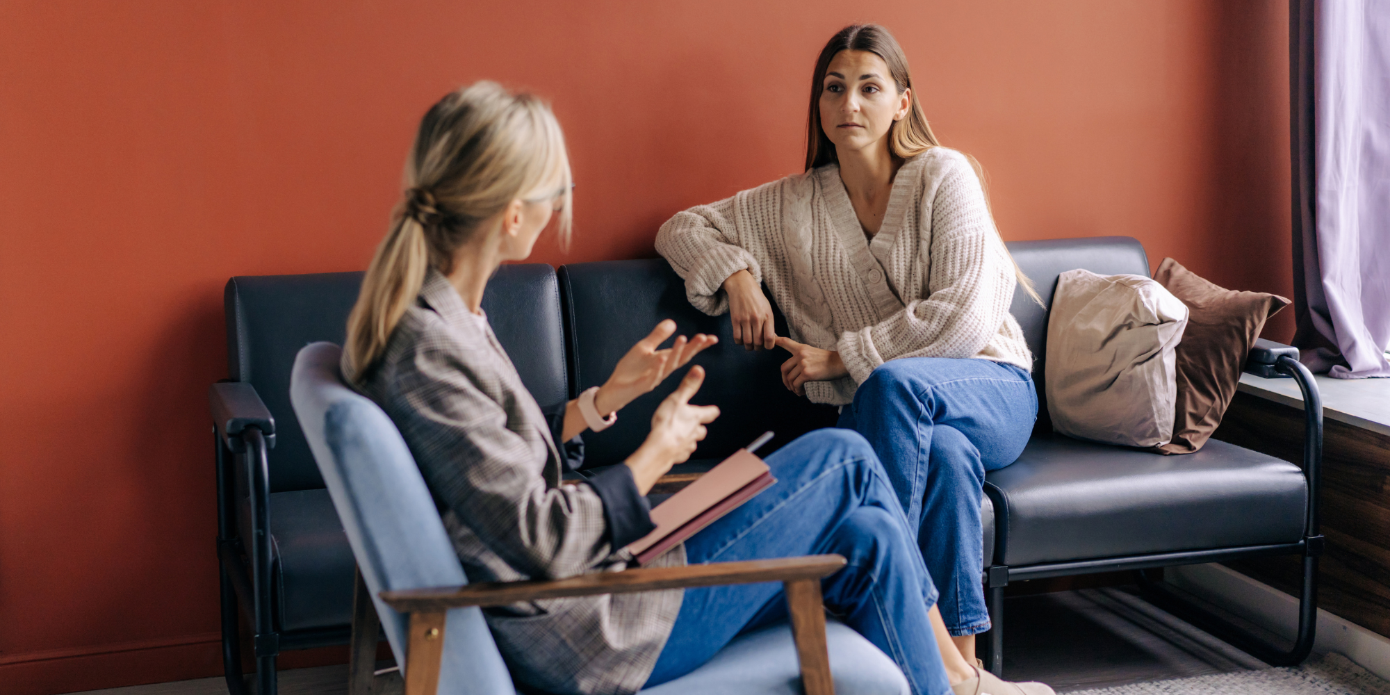 two women sitting down talking about abortion
